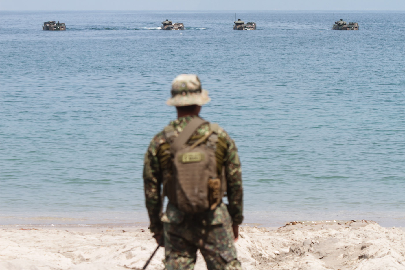 JOINT DRILLS. A Philippine Marine soldier watches as amphibious assault vehicles approach the beach in Ternate, Cavite, during the 2019 Kamandag joint exercises with the US. Photo by Lito Borras/Rappler 