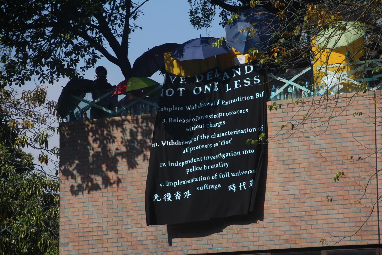 DEMANDS. Protesters list their demands to the Hong Kong government in a black banner. Photo by Tommy Walker  