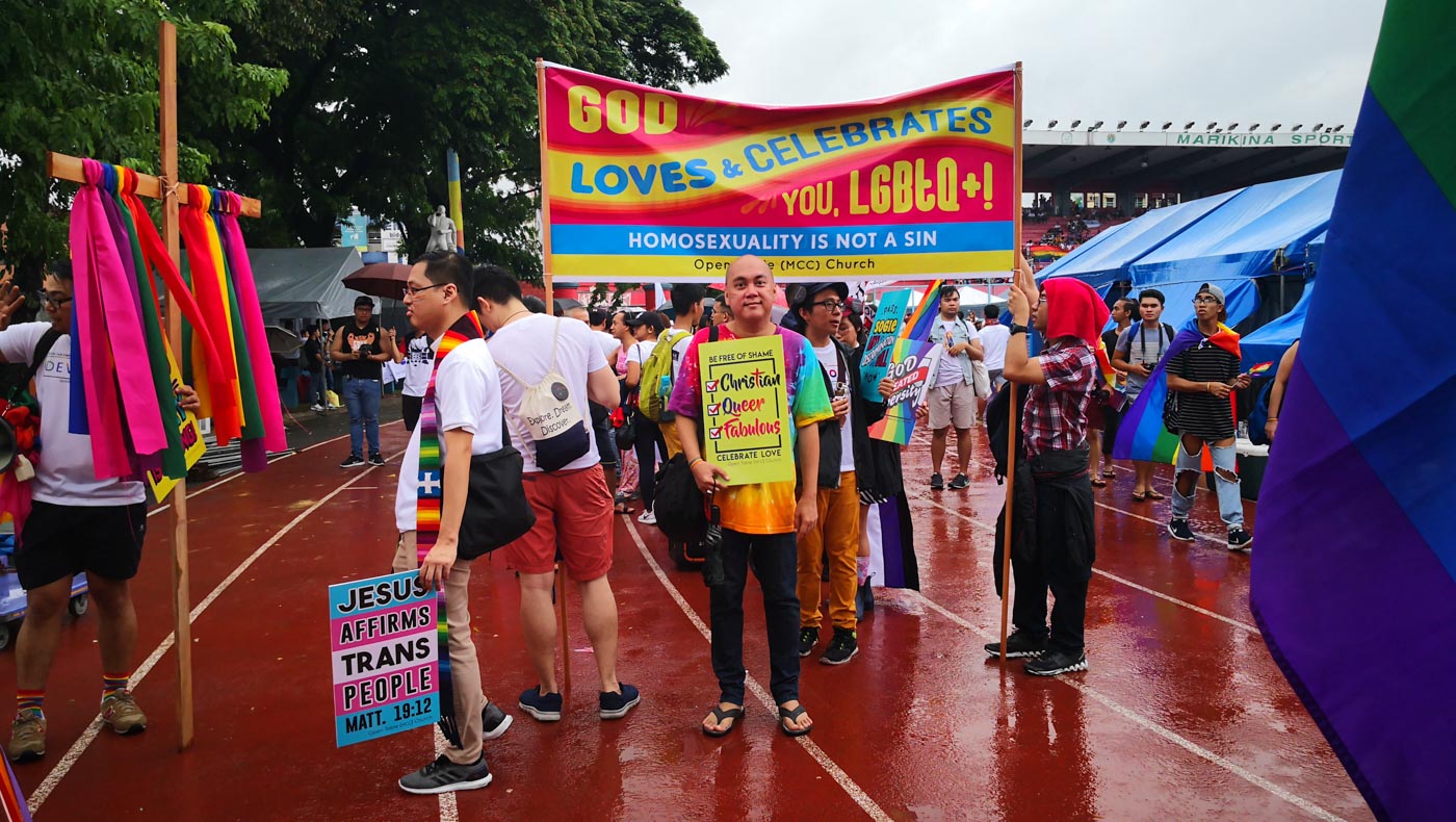 'GOD IS ON YOUR SIDE'. Members of the Metropolitan Community Church bearing placards in support of the LGBTQ+ community during the Metro manila Pride March 2019. Photo by Russel Patina/Rappler 