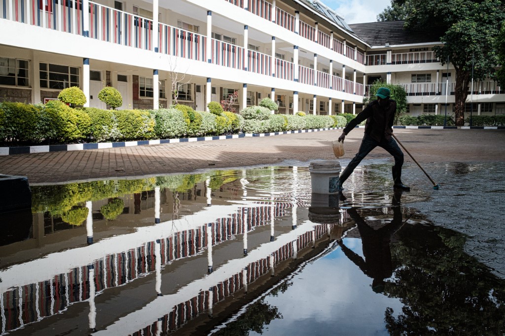 CLOSED. In this file photo, a staff clears a puddle of rain at Saint Hannah's School closed due to the novel coronavirus COVID-19, in Nairobi, on April 29, 2020. File photo by Yasuyoshi Chiba/AFP 