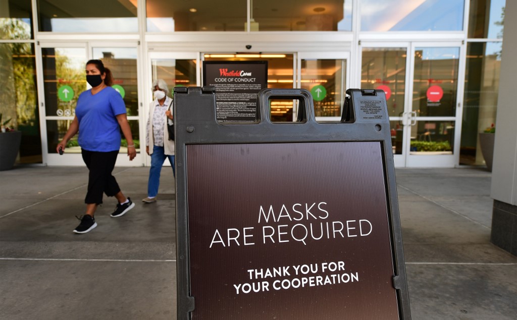 FACE MASKS REQUIRED. Women exit a shopping mall where a sign is posted at an entrance reminding people of the mask requirement, in Arcadia, California, on June 12, 2020. Photo by Frederic J. Brown/AFP 