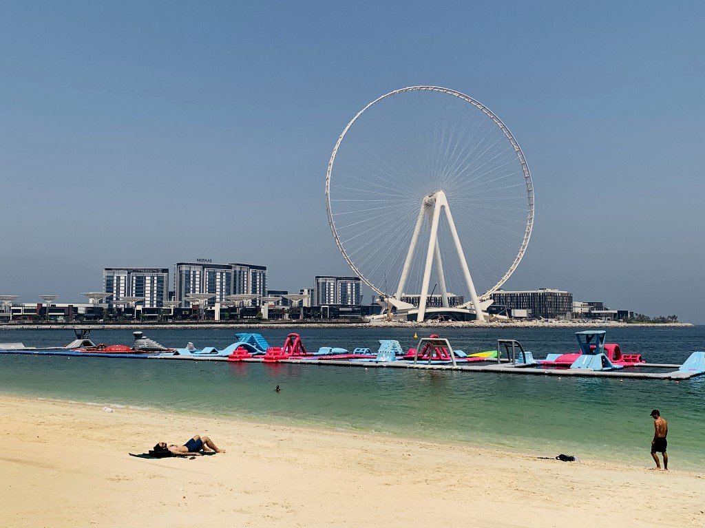 TOURISM. A man sunbathes along the Marina beach near the Ain Dubai ferris wheel in the Gulf emirate of Dubai on July 7, 2020. Photo by Giuseppe Cacace/AFP 