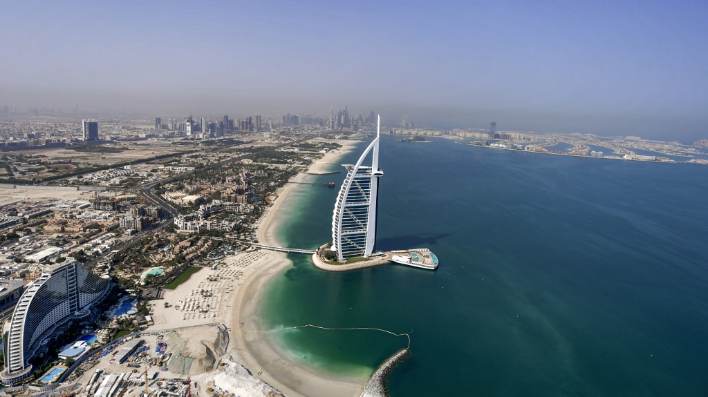 DUBAI. An aerial view of the Burj al-Arab hotel in the Gulf emirate of Dubai, with the man-made Palm Jumeirah archipelago seen in the background, during a government-organized helicopter tour on July 8, 2020. Photo by Karim Sahib/AFP 