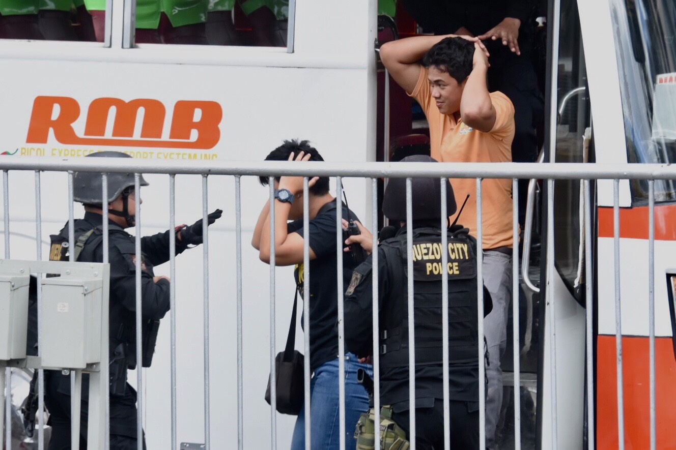 RELEASED. Hostages walk out the bus after police shoot down Suspect B.
Photo by Angie de Silva/Rappler 