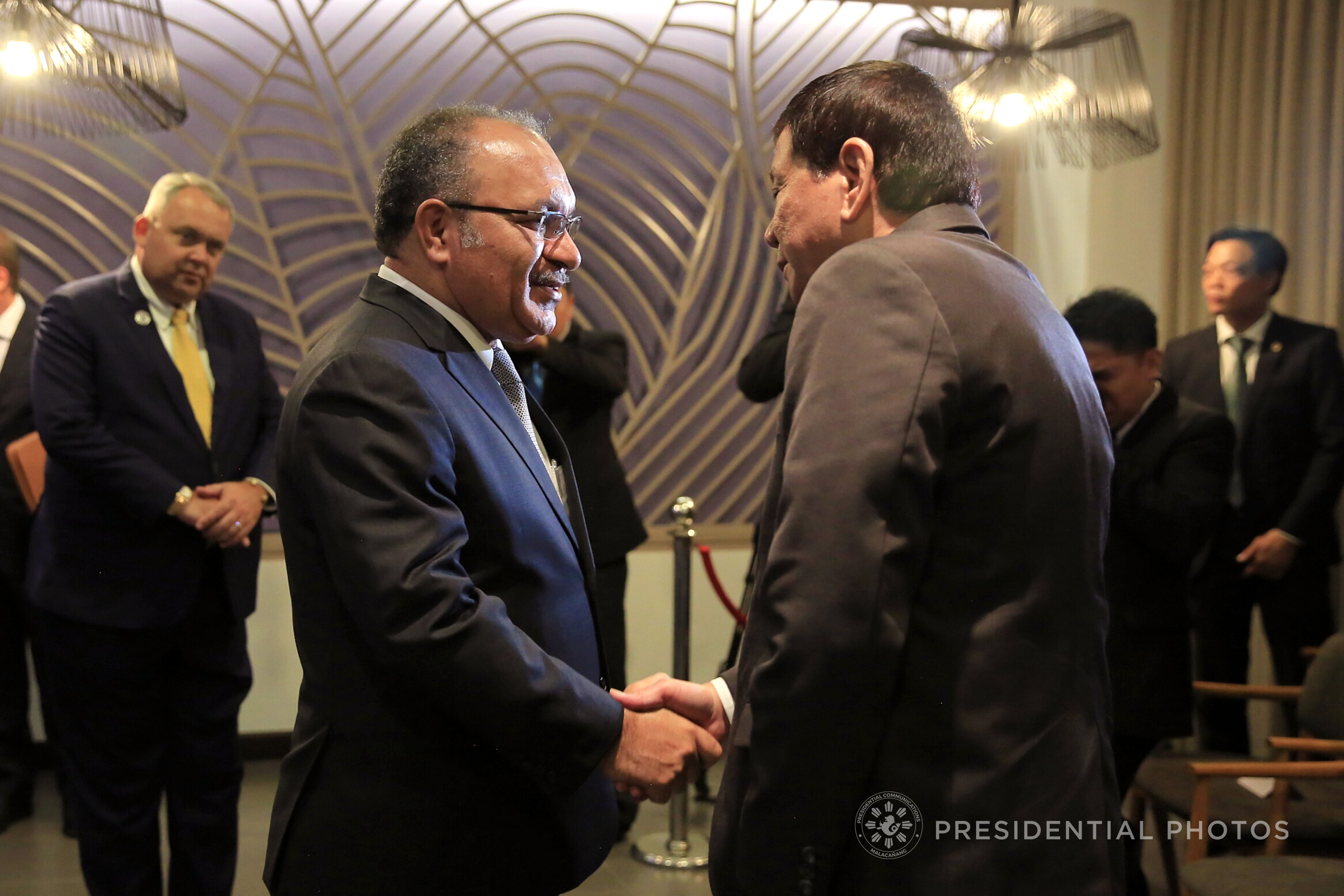 THIS YEAR'S APEC HOST. President Rodrigo Duterte greets Papua New Guinea Prime Minister Peter O'Neill during the APEC Summit in 2017 in Vietnam. Malacañang file photo
 