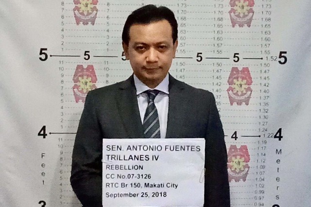 ARRESTED. Senator Antonio Trillanes IV undergoes booking procedures inside the Makati City Police Station. NCRPO photos 