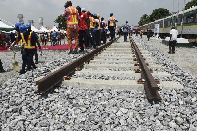 RAIL PROJECT. Workers stand along a prototype rail line in Lagos on March 7, 2017, during the groundbreaking for the construction of the Lagos-Ibadan rail line project, to be built by China. File photo by Pius Utomi Ekpei/AFP 