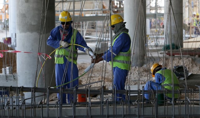 FOREIGN WORKERS. This file photo taken on October 03, 2013 shows migrant laborers working on a construction site on October 3, 2013 in Doha in Qatar.  Karim Jaafar/AFP 