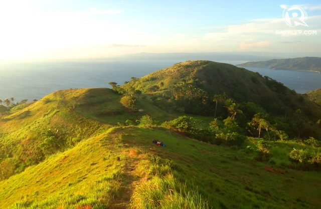 SUMMITVIEW. Look down at rolling green hills and blue seas from Gulugod Baboy's peak.  
