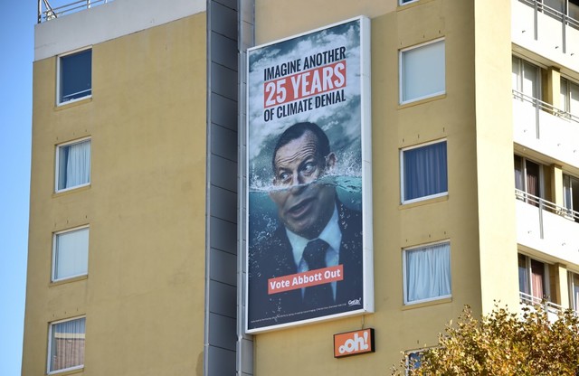 'VOTE ABBOTT OUT.' Photo taken on May 12, 2019 shows a pro-climate change election sign in Sydney featuring climate change skeptic and former prime minister Tony Abbott ahead of the Australian election. Photo by Peter Parks/AFP 