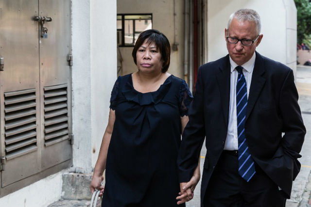 CHARGES. This photo shows Philippine national Herminia Garcia (L) and her British businessman partner Nick Cousins (R) arriving at the Eastern Magistrate Court in Hong Kong. Photo by Anthony Wallace/AFP
 