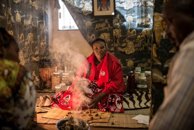 DAGGA MEDICINE. Gogo Phephisile Maseko, a traditional healer and national coordinator of the Traditional Healers Organisation (THO) of South Africa attends to patients on October 1, 2018 using a blend of cannabis and other herbs in a consultation room at their offices in Johannesburg. Photo by Gulshan Khan/AFP  