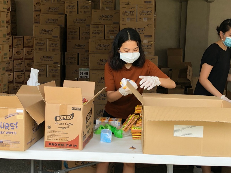 FOR THE FRONTLINERS. Volunteer staff from Jesse M. Robredo Foundation and Kaya Natin! Movement repack groceries and vitamins for the care packages for the frontline workers. Photo from Kaya Natin! Movement