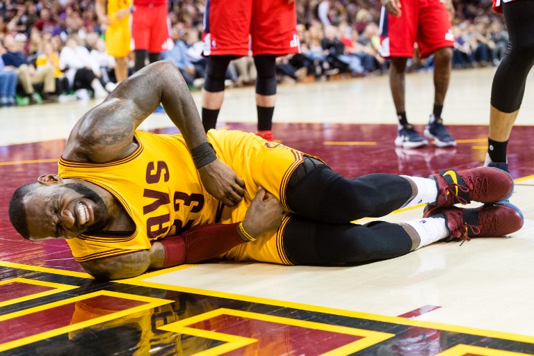 WATCH LeBron James goes down in pain after knee to the groin