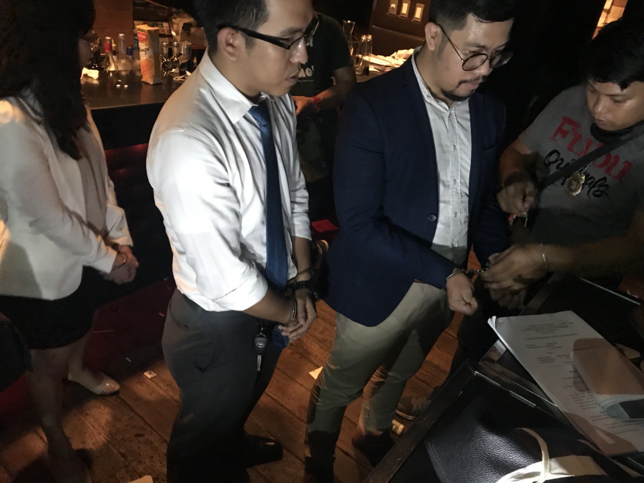 OBSTRUCTION? Cops detain lawyers at the Makati Police Station on August 16, 2018, for taking notes and photos during a police inventory of a raided bar. Photo courtesy of the Southern Police District 