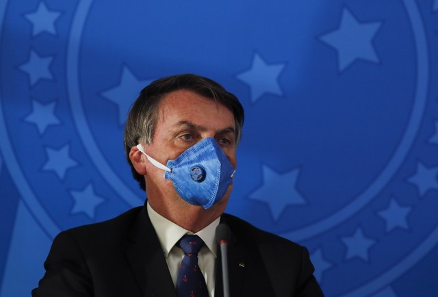 BOLSONARO. Brazil's President Jair Bolsonaro wears a face mask during a press conference on the coronavirus pandemic at the Planalto Palace in Brasilia, Brazil on March 20, 2020. Photo by Sergio Lima / AFP 