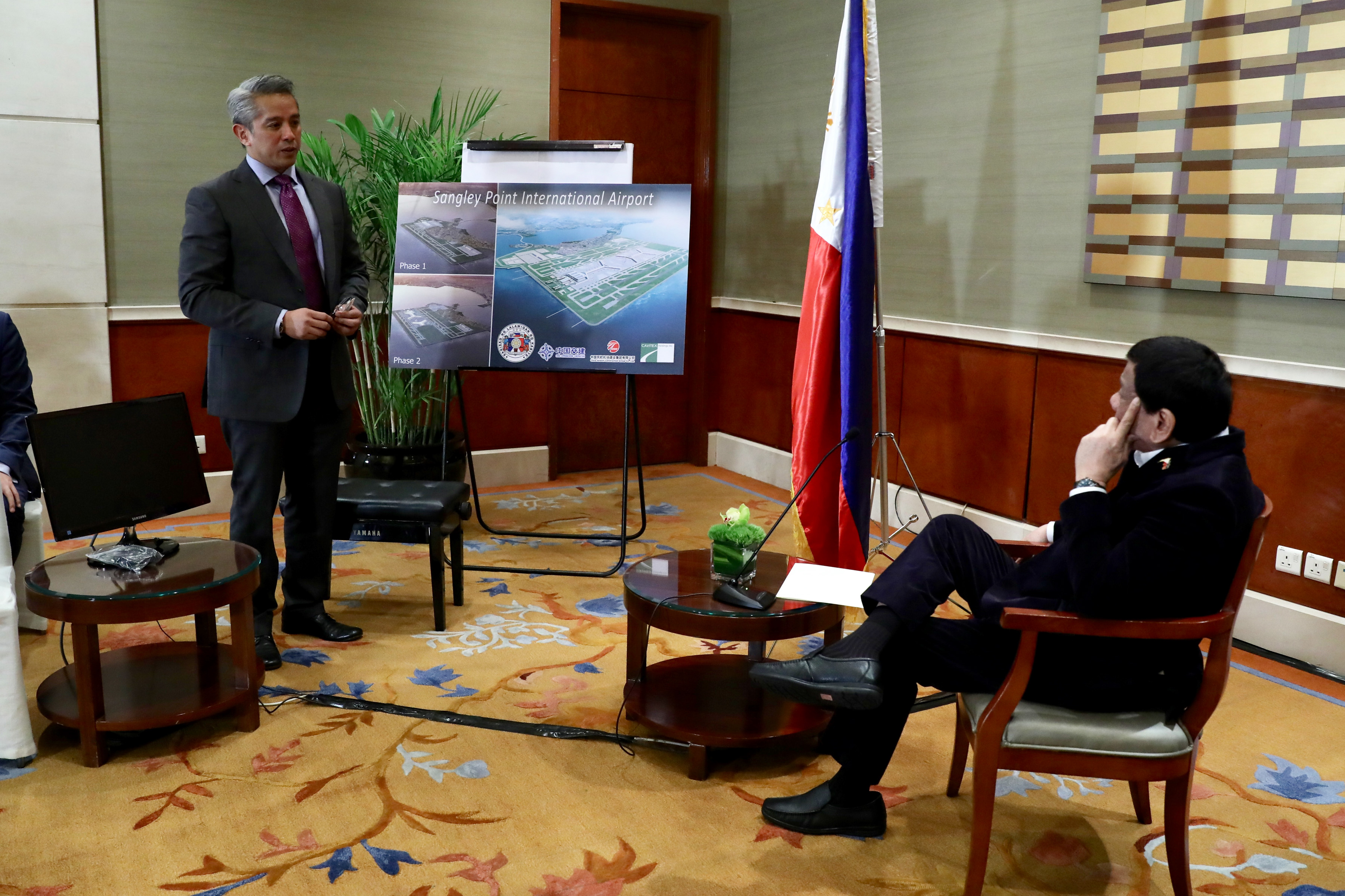 CAVITE'S PITCH. President Rodrigo Duterte looks on as Cavite Governor Juanito Victor Remulla Jr presents the architect's perspective of the Sangley Point International Airport during the courtesy call on the President at the Grand Hyatt Hotel in Beijing on August 30, 2019. Malacañang Photo 