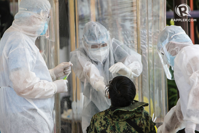 HEALTH WORKERS. Members of the Northern Police District undergo swab tests to detect a possible COVID-19 infection in People's Park in the city of Caloocan. Photo by Ben Nabong / Rappler 