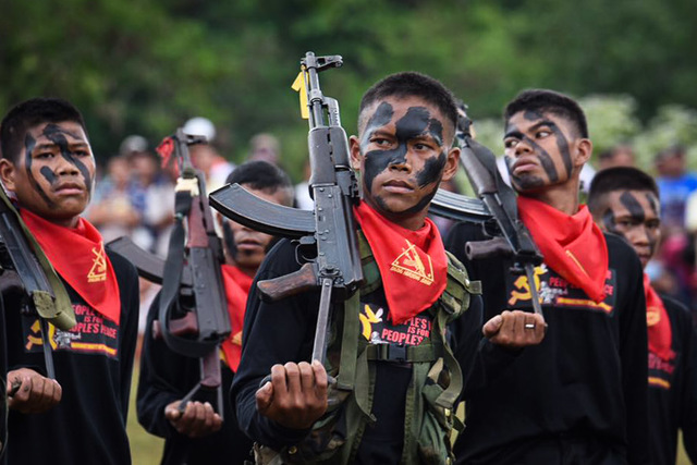 FIVE DECADES. File photo of New People's Army guerrillas marching in Davao City to celebrate the 48th founding anniversary of the Communist Party of the Philippines on December 26, 2016.  