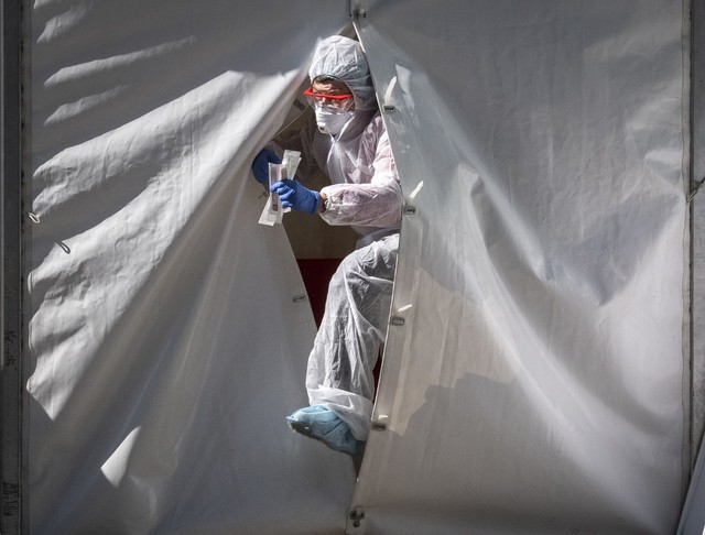 CORONAVIRUS CRISIS. A medical team exits a tent from a coronavirus test point in central Moscow on May 2, 2020. Photo by Yuri Kadobnov / AFP  