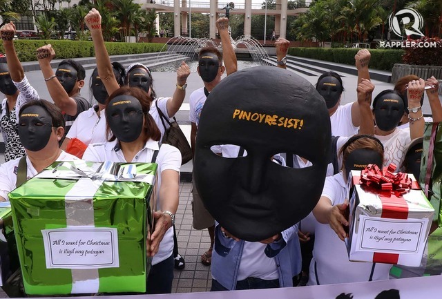 RESIST. Human rights advocates wearing masks urge Filipinos to resist amid human rights violations under Duterte. Photo by Darren Langit/Rappler 