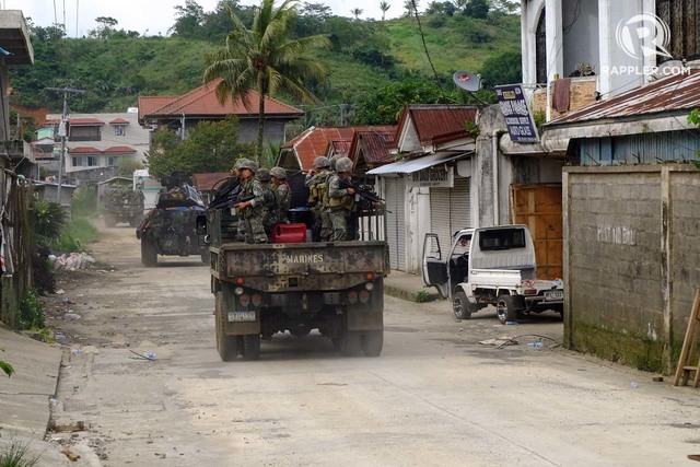 MARAWI CLASHES. A convoy of Philippine Marines passes through Barangay Saduc on June 6, 2017, as clashes continue in Marawi City. Photo by Bobby Lagsa/Rappler  