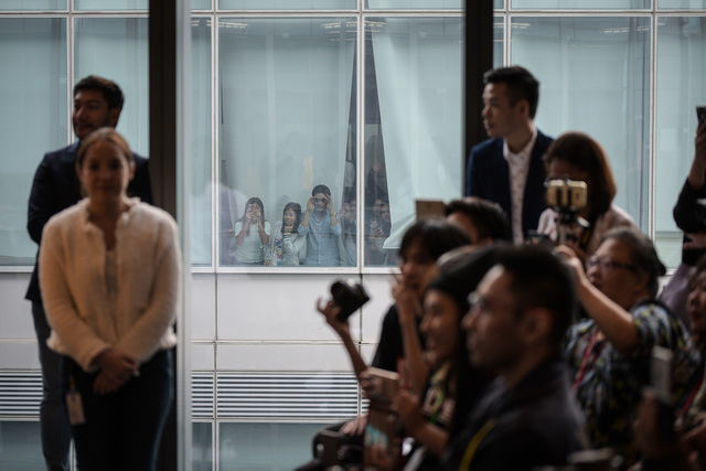 MANILA MERRIES. Fans from the neighboring building peer through their window to catch a glimpse of their idols. 