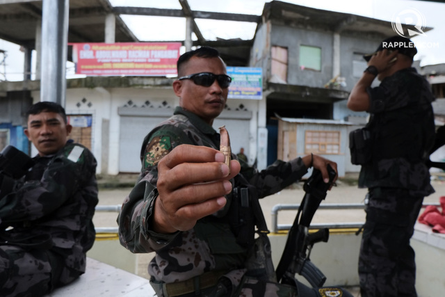 DANGER IN MARAWI. A policeman shows a .50mm caliber bullet from the Maute Group sniper who fired on them. File photo by Bobby Lagsa/Rappler 