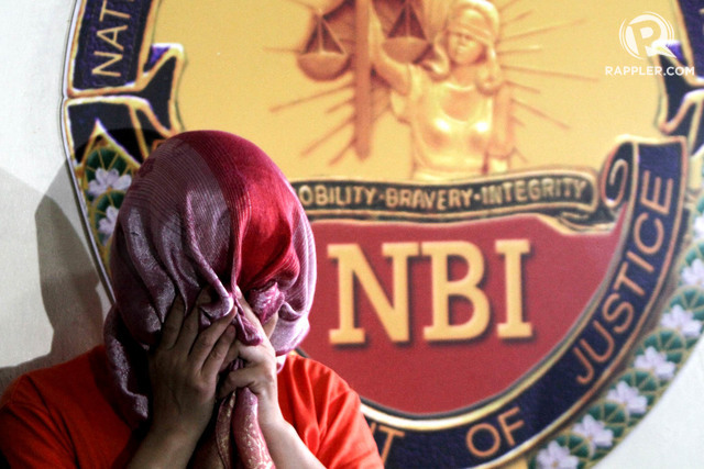 BANK FRAUD. Bank officer Maria Victoria Lopez uses a scarf to hide her face at an NBI news briefing on the Metrobank internal fraud case on July 21 2017. Photo by Inoue Jaena/Rappler 