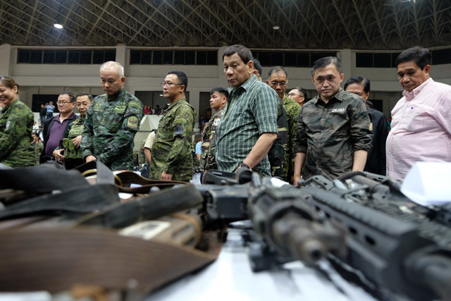 SURRENDERED. In this file photo from May 11, 2018, President Rodrigo Duterte leads the inspection of the firearms surrendered by the ISIS-Maute Group at the Capitol Gymnasium in Sacayo, Marawi City. MalacaÃ±ang photo 