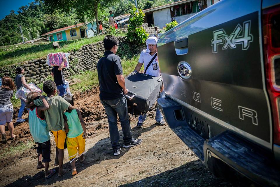 Unloading the first of many packs of slippers, books, and other school materials 